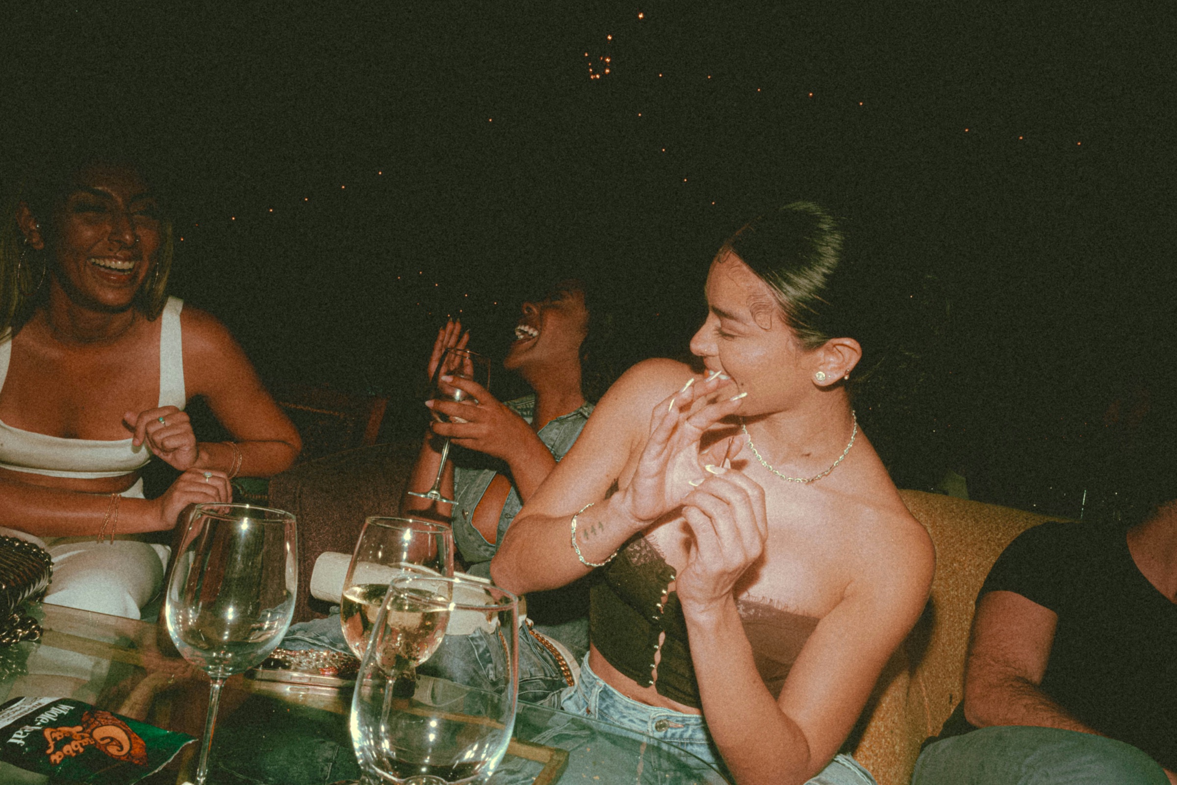 Guests laughing together around a table at a Just Singles Dubai dinner